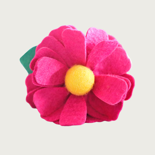 Hot pink felt collar flower with a yellow center and green leaf.