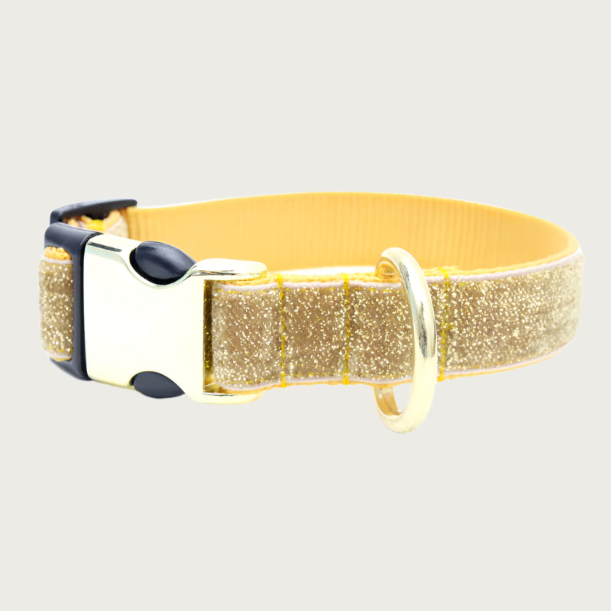 Gold glittery dog collar with golden yellow nylon webbing interior, hybrid black plastic & silver metal clip, and gold D-ring.