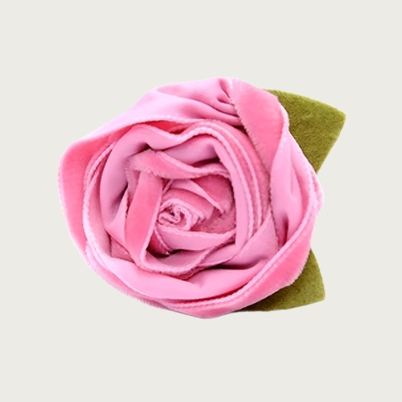 Pink velvet dog collar flower with green leaves.