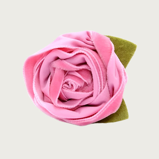 Pink velvet dog collar flower with green leaves.