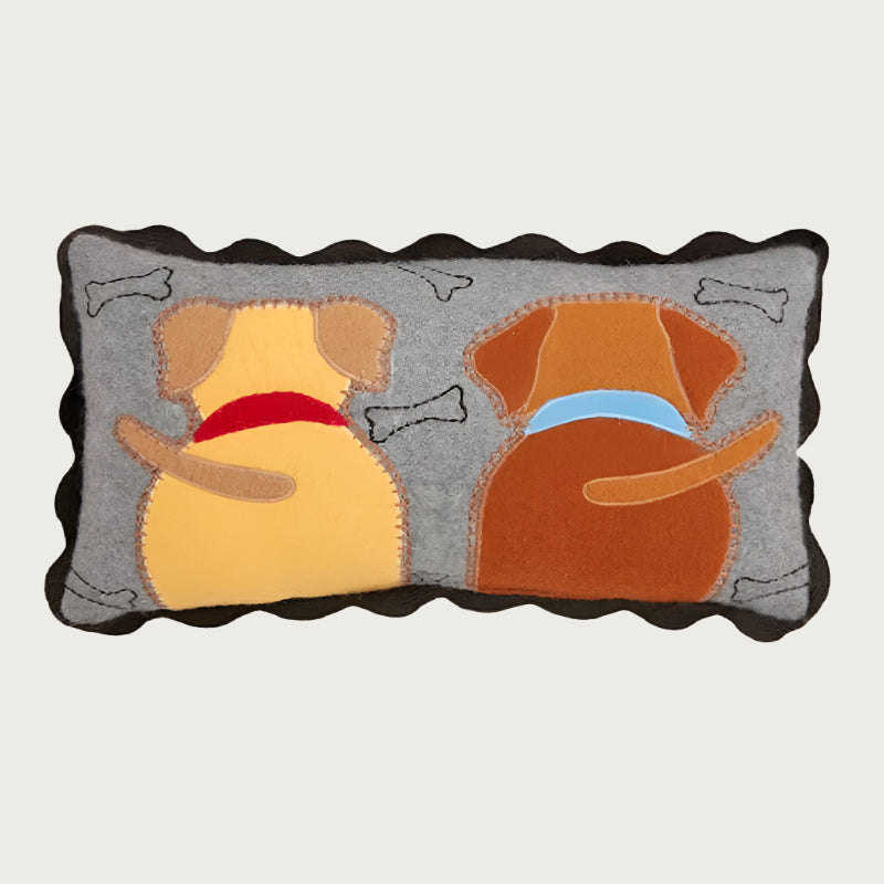 Decorative throw pillow with two dogs seen from behind. One is yellow with a red collar and the other is brown with a blue collar. Base color is gray with black scalloped trim, with black embroidered outlined dog bones around the dogs.