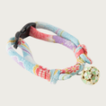 Load image into Gallery viewer, Cat collar with a pastel blue, purple & coral Asian-inspired print. Each knotted end has a loop for adjusting the collar's size up or down. A round gold charm is attached, with enameled four-leaf clover motif in cream & pale green.
