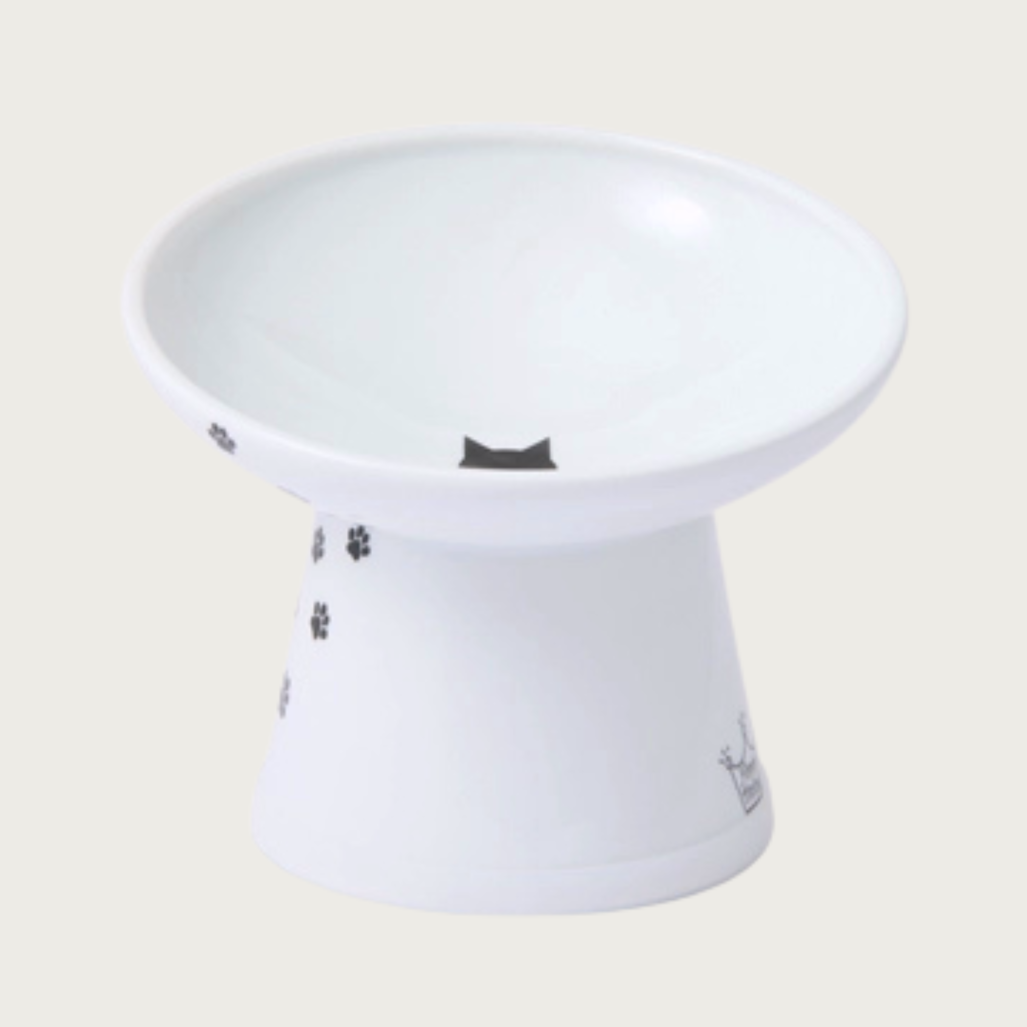 Front view of the tilted, raised, cat food bowl with black paw print design trailing up the side, and a small black cat head silhouette in the center. Back of bowl is much higher than the front.