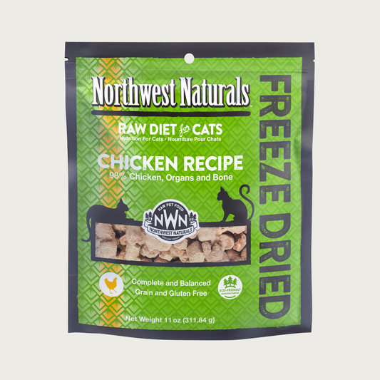 An 11 ounce green bag of Northwest Naturals freeze-dried raw diet for cats, chicken recipe. Clear window on bag shows small bite-sized nibbles.