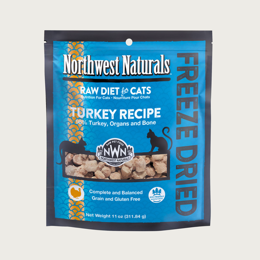 An 11 ounce blue bag of Northwest Naturals freeze-dried raw diet for cats, turkey recipe. Clear window on bag shows small bite-sized nibbles.