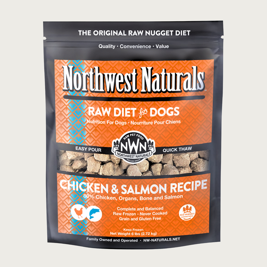 A 6 pound orange bag of Northwest Naturals frozen raw diet for dogs, chicken and salmon recipe. Clear window on bag shows small cube-sized nuggets.