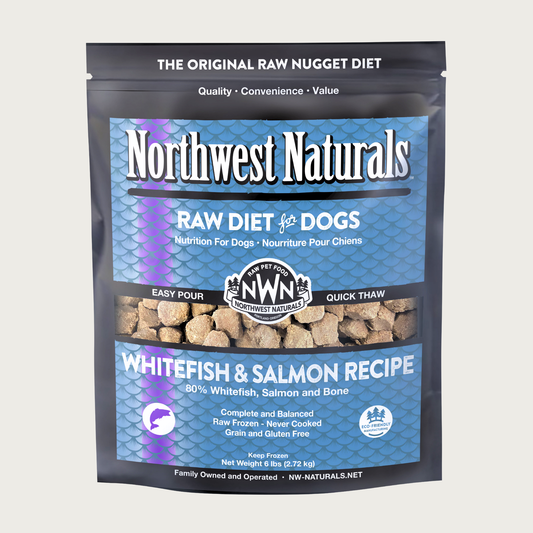 A 6 pound blue bag of Northwest Naturals frozen raw diet for dogs, whitefish and salmon recipe. Clear window on bag shows small cube-sized nuggets.