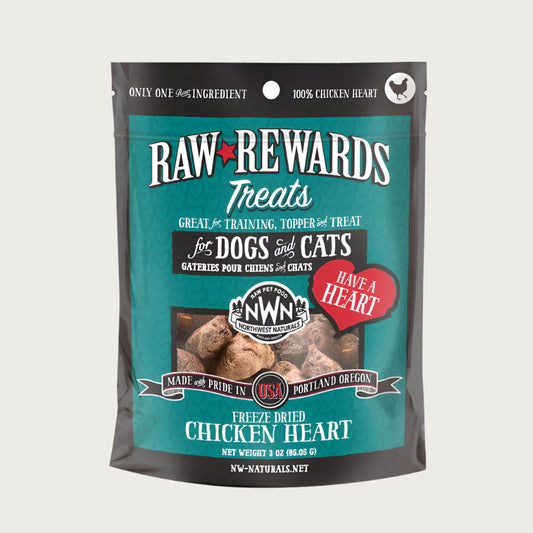 A 3 ounce bag of Northwest Naturals freeze-dried raw chicken heart treats for dogs and cats. Clear window on bag shows small rectangular shaped pieces.