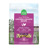 A 9 oz bag of Grain Free, Open Farm Freeze-Dried-Raw Chicken & Salmon Recipe cat food. Meal or Mixer, Humanely raised and sustainably sourced. A photo of a gray cat standing in a field on a farm covers the bag, with a magenta bar in the center to highlight the white text over it.