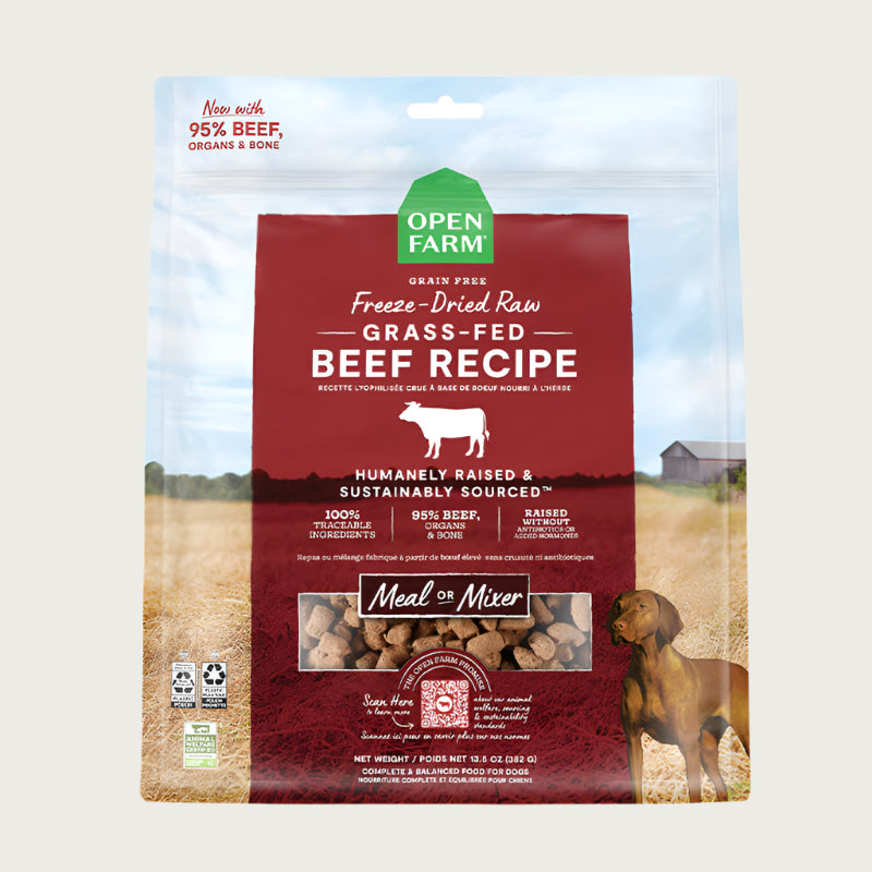 A 13.5 oz bag of Grain Free, Open Farm Freeze-Dried-Raw Grass-Fed Beef Recipe dog food. Meal or Mixer, Humanely raised and sustainably sourced. A photo of a Vizsla dog standing in a field on a farm covers the bag, with a red bar in the center to highlight the white text over it.