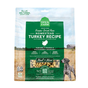 A 13.5 oz bag of Grain Free, Open Farm Freeze-Dried-Raw Homestead Turkey Recipe dog food. Meal or Mixer, Humanely raised and sustainably sourced. A photo of a Pointer dog standing in a field on a farm covers the bag, with a green bar in the center to highlight the white text over it.
