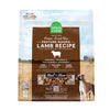 A 13.5 oz bag of Grain Free, Open Farm Freeze-Dried-Raw Pasture-Raised Lamb Recipe dog food. Meal or Mixer, Humanely raised and sustainably sourced. A photo of a Boxer dog standing in a field on a farm covers the bag, with a brown bar in the center to highlight the white text over it.