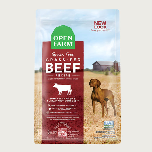 A bag of Open Farm Grain Free Beef Recipe dog food. Humanely raised and sustainably sourced. A photo of a Vizsla dog standing in a field on a farm covers the bag, with a red bar behind the white text to highlight it.