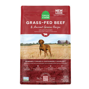 A bag of Open Farm Beef & Ancient Grains Recipe dog food. Humanely raised and sustainably sourced. A photo of a Vizsla dog standing in a field on a farm is in the center 1/3 of the bag, with a red band on the top 1/3 and bottom 1/3 behind white text to highlight it.