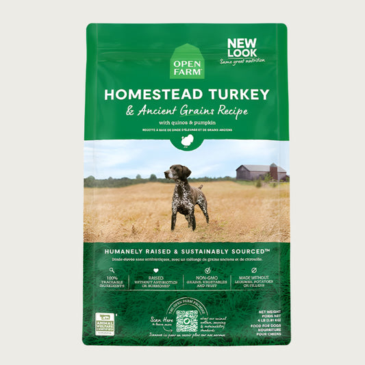 A bag of Open Farm Turkey & Ancient Grains Recipe dog food. Humanely raised and sustainably sourced. A photo of a Pointer dog standing in a field on a farm is in the center 1/3 of the bag, with a green band on the top 1/3 and bottom 1/3 behind white text to highlight it.