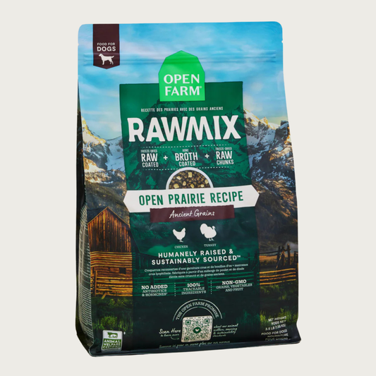 A bag of Open Farm RawMix Ancient Grains Open Prairie Recipe dog food. Humanely raised and sustainably sourced. A mountain ranch scene is in the background of the bag, with a vertical green bar behind the white text to highlight it.