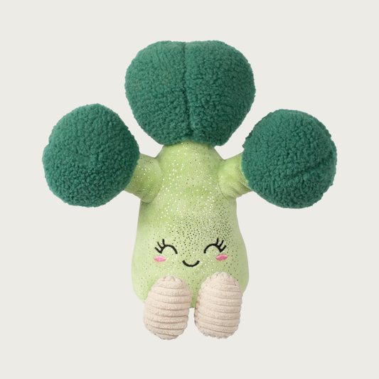 Plush dog toy shaped like a large broccoli floret with stem. Its body is light green with tiny silver sparkles, and a cute embroidered face. It has cream corduroy legs and dark green, round, faux sheepskin florets on top.