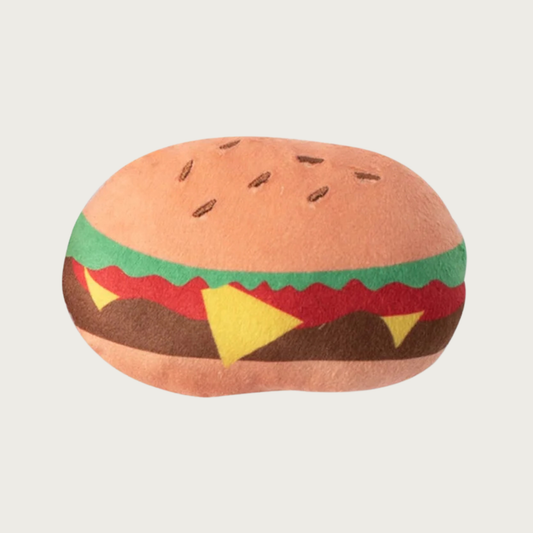 Hamburger-shaped small plush dog toy, with multi-colored layers. Its design is printed on fabric, there are no textured or dimensional layers.