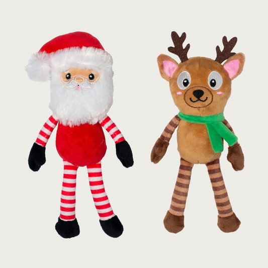 Full body, plush Santa Claus and Reindeer dog toys, side by side. Santa is wearing his hat and has a red body, and red & white striped arms & legs. The reindeer is wearing a green scarf, and has a brown body with dark & light brown striped arms & legs.