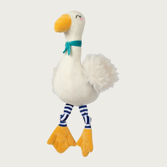 Plush white goose dog toy with fuzzy faux fur wings, a yellow beak and feet, with navy blue & white striped legs, and wearing a teal scarf. Sweet embroidered facial details.