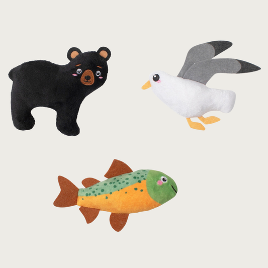 Three small plush toys: a black bear, a white & gray seagull, and a green & brown fish.