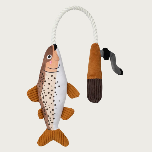 Plush dog toy shaped like a brown trout connected with a white rope to a plush fishing reel.