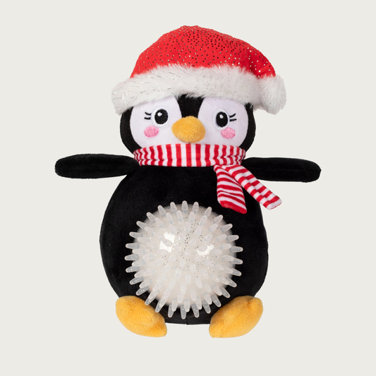 Plush full body penguin dog toy wearing a Santa hat and red & white scarf. Its belly is a white, glittery & spiky rubber ball that sticks out.