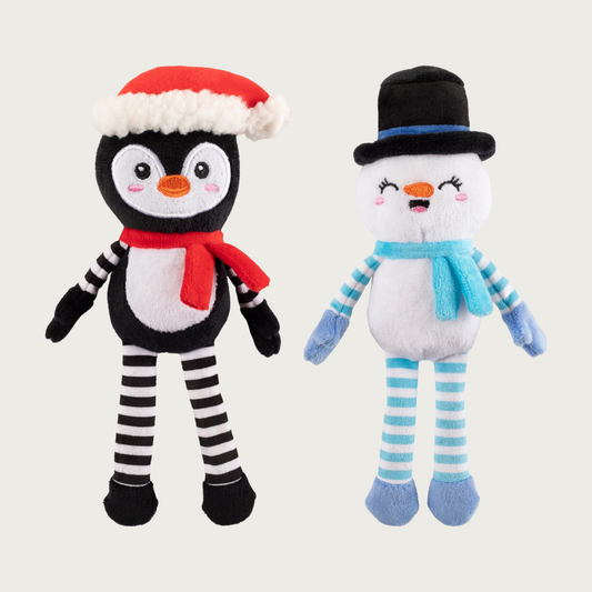 Full body, plush penguin & snowman dog toys, side by side. Penguin is wearing a Santa hat & red scarf, has a black & white body, and black & white striped arms & legs. The snowman is wearing a black top hat & light blue scarf, and has a white body with light blue & white striped arms & legs.