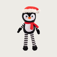 Load image into Gallery viewer, Full body, plush penguin dog toy wearing a Santa hat & red scarf, has a black & white body, and black & white striped arms & legs.
