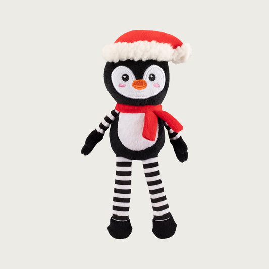 Full body, plush penguin dog toy wearing a Santa hat & red scarf, has a black & white body, and black & white striped arms & legs.