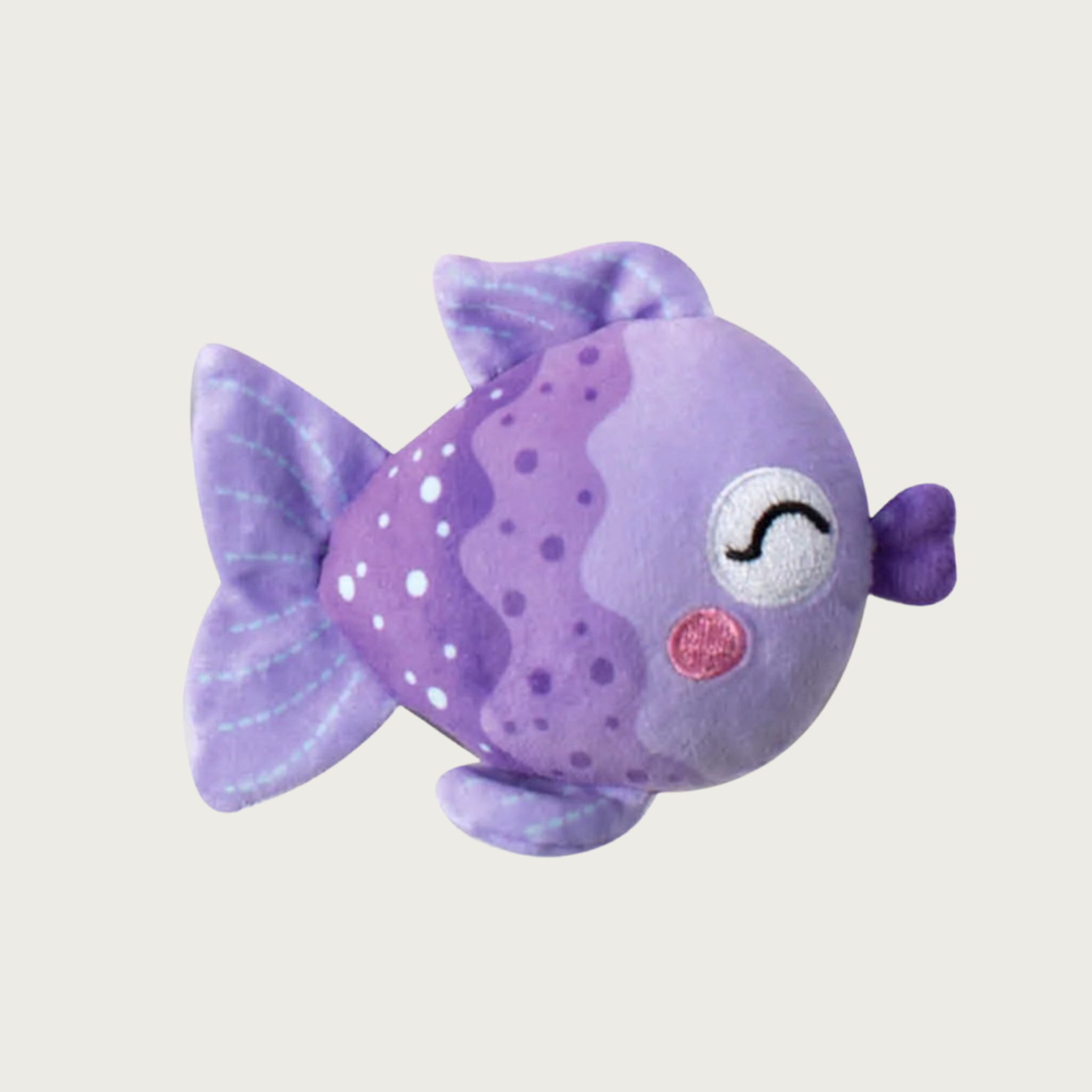 A purple plush fish dog toy with embroidered closed eyes, pink rosy cheeks, and white & purple dots and wavy line details on its body.