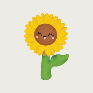 Latex dog toy in the shape of a sunflower. Green stem and leaf, yellow petals and brown face with a cute expression.