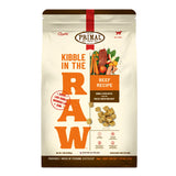 A 1.5 pound bag of beef recipe Kibble in the Raw dog food from Primal Pet Foods. Text on bag reads "Kibble sized bites made with freeze-dried raw beef" and "Serve like kibble. Nourish like raw." There is an image of fresh produce and a piece of raw steak, and a smaller image of the bite-sized morsels that are in the bag.