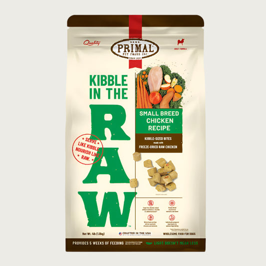 A 4 pound bag of small breed chicken recipe Kibble in the Raw dog food from Primal Pet Foods. Text on bag reads "Kibble sized bites made with freeze-dried raw chicken" and "Serve like kibble. Nourish like raw." There is an image of fresh produce with a raw chicken breast, and a smaller image of the bite-sized morsels that are in the bag.