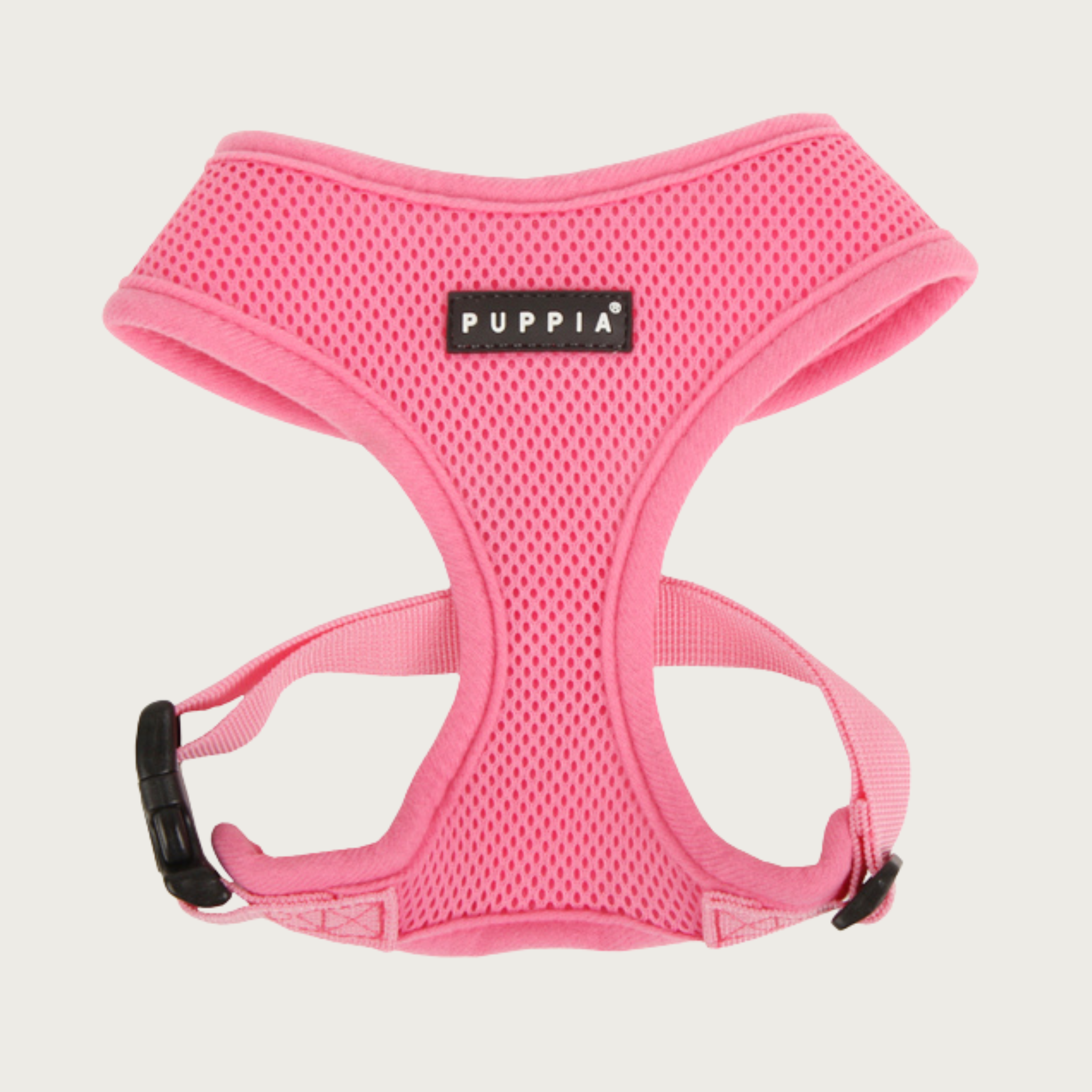 Soft mesh, bubblegum pink colored dog harness with black & white 'Puppia' brand tag on chest.