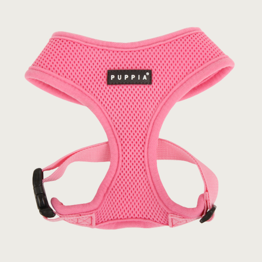 Soft mesh, bubblegum pink colored dog harness with black & white 'Puppia' brand tag on chest.