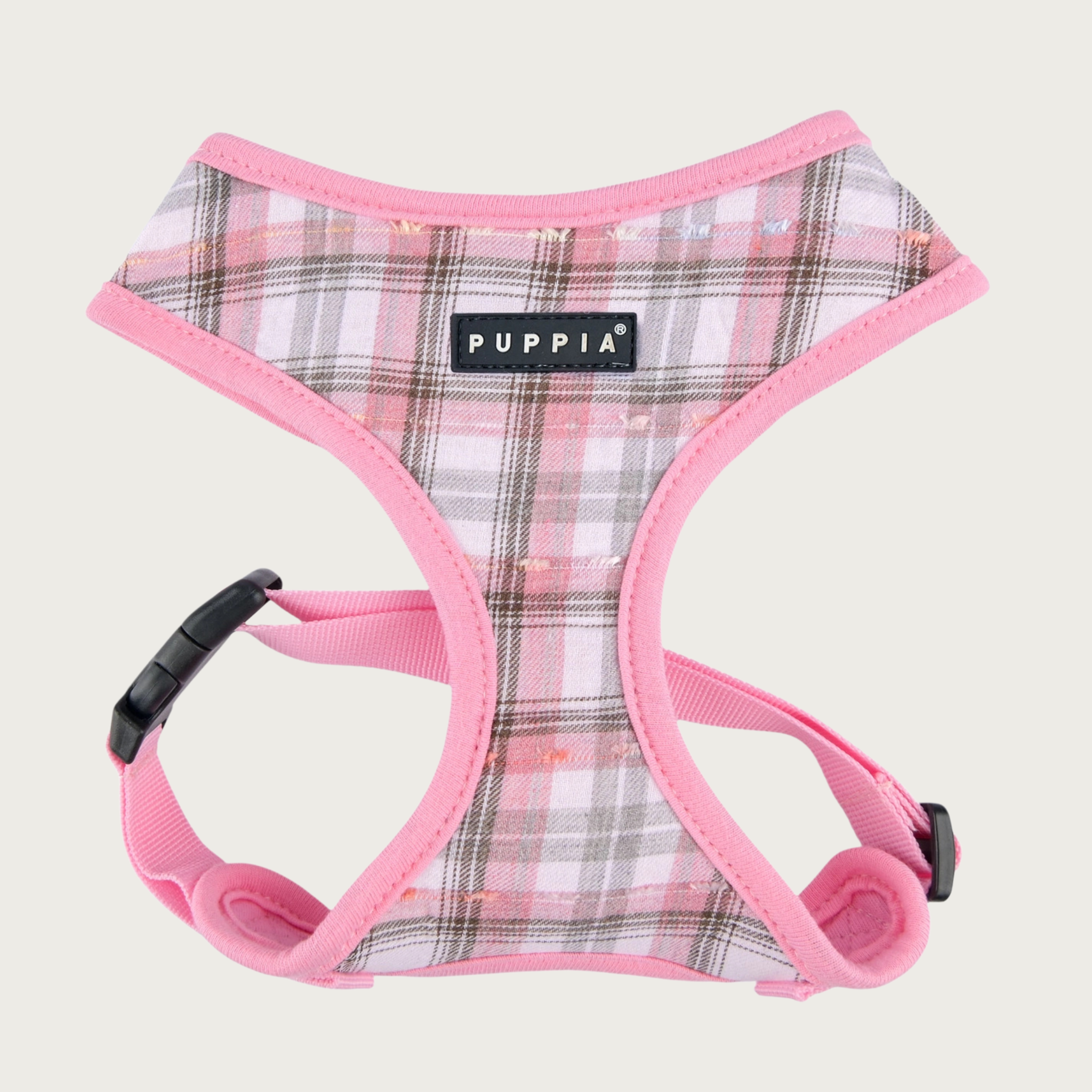 Plaid dog harness with a white base color, with black, gray, and pink plaid with pink trim on edges, with a black & white Puppia label in the center of the chest.