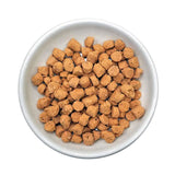 A bowl of Quest frozen raw cat food nuggets. They are small, bite-sized nuggets that are about the size of a pencil eraser.