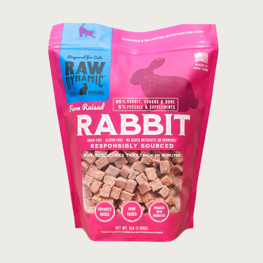 Raw Dynamic Raw Rabbit frozen raw cat food in a pink bag, made from responsibly sourced rabbit, grain-free, all-natural, and rich in protein for healthy cats.