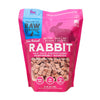 Raw Dynamic Raw Rabbit frozen raw cat food in a pink bag, made from responsibly sourced rabbit, grain-free, all-natural, and rich in protein for healthy cats.