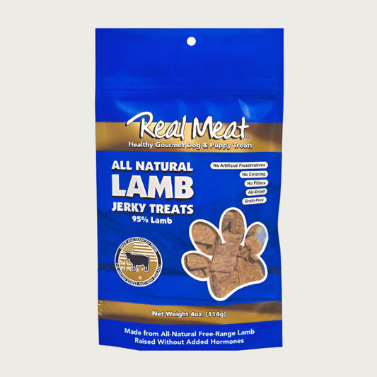 4 oz blue bag of all natural lamb jerky dog & puppy treats from The Real Meat Company. 95% lamb, no fillers. Small, clear, paw print shaped window on bag shows product inside - brown, rectangular shaped treats.