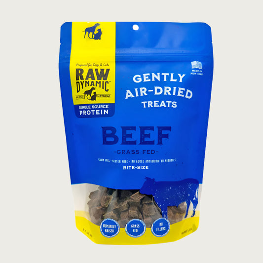 Raw Dynamic Gently Air Dried Beef treats for dogs and cats in a small blue bag, made from grass fed beef, grain-free, all-natural, and rich in protein for healthy pets. Bite sized treats.
