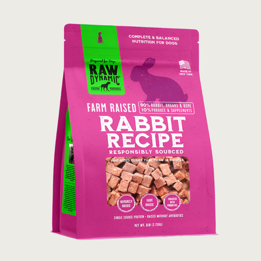 Raw Dynamic Frozen Raw Rabbit dog food in a pink bag, made from farm raised rabbit, grain-free, all-natural, and rich in protein for healthy dogs. Packaged in a 6 pound bag.