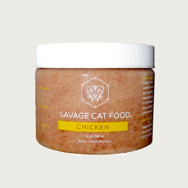 A 12 oz plastic tub of Savage Cat Food, Chicken recipe for cats. Tub is clear, with light reddish brown food inside. Raw. Keep Frozen.
