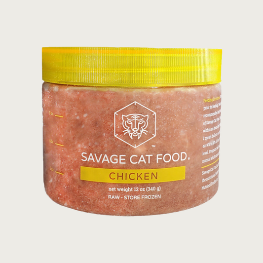 A 12 oz plastic tub of Savage Cat Food, Chicken recipe for cats. Tub is clear, with light reddish brown food inside. Lid is yellow. Raw. Keep Frozen.