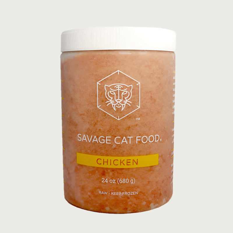 A 24 oz plastic tub of Savage Cat Food, Chicken recipe for cats. Tub is clear, with light reddish brown food inside. Raw. Keep Frozen.