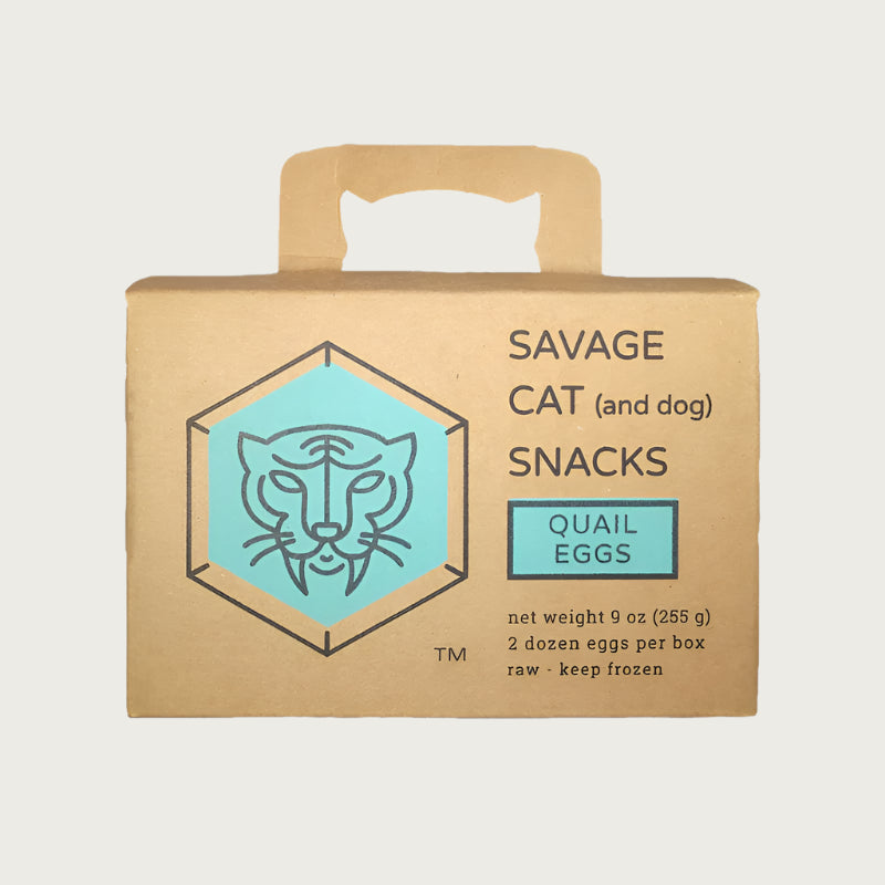 A small cardboard box with handle, containing 9 oz (2 dozen) frozen raw quail eggs from Savage Cat.