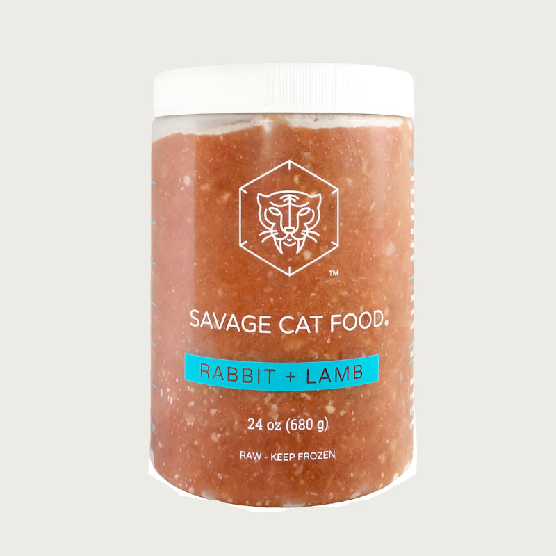 A 24 oz plastic tub of Savage Cat Food, Rabbit and Lamb recipe for cats. Tub is clear, with reddish food inside. Raw. Keep Frozen.