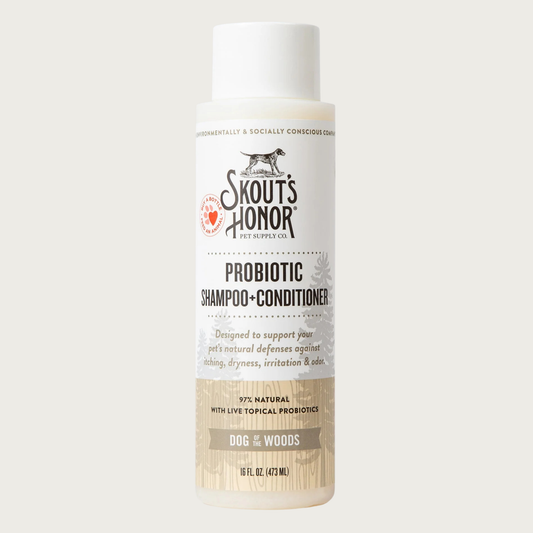 Opaque white plastic bottle of Skout's Honor Probiotic Shampoo & Conditioner in Dog of the Woods. 97% natural with live topical probiotics. Designed to support your pet's natural defenses against itching, dryness, irritation & odor. 16 Fl Oz.