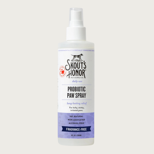 Opaque white spray bottle of Skout's Honor Probiotic Paw Spray for daily-use. 98% natural, non-medicated, alcohol-free, fragrance-free. Long-lasting relief for itchy, stinky, irritated paws. 8 Fl Oz.